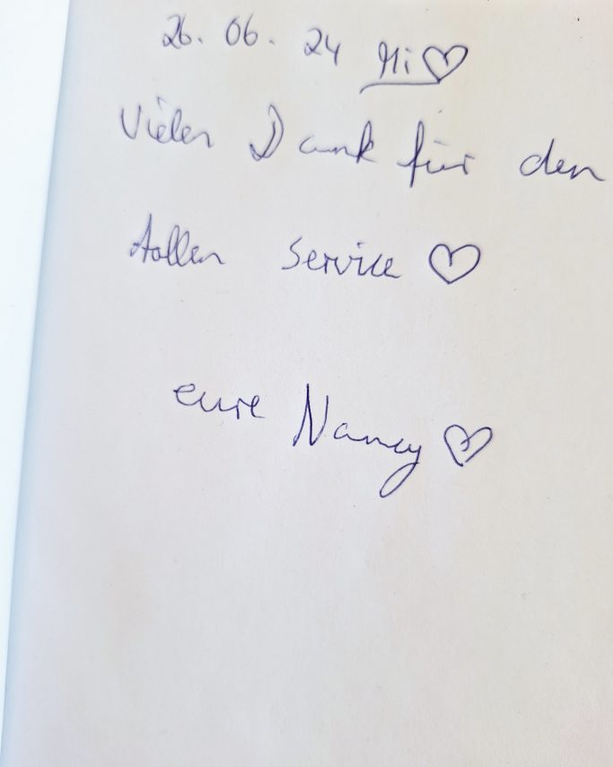 Handschriftliche Notiz mit Datum, herzlichem Gruß und Hinweis auf einen Service.