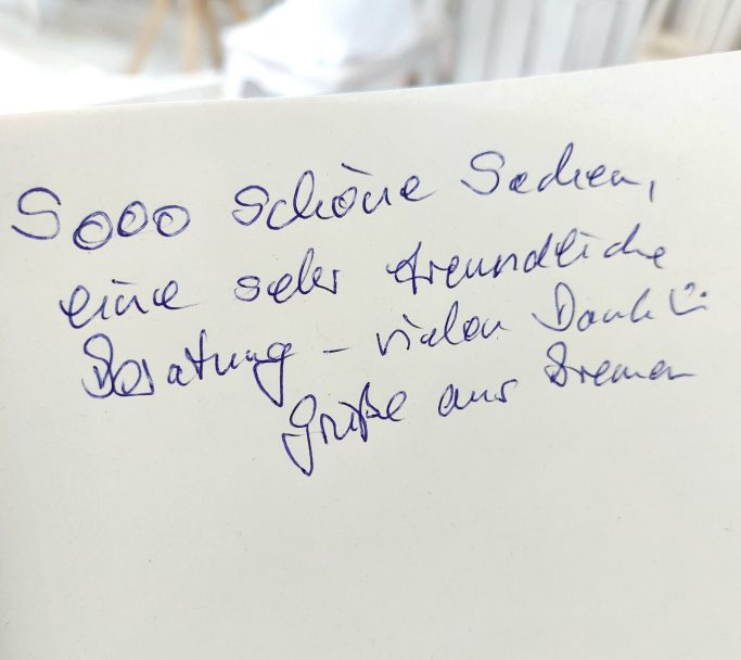 Notiz auf einem Blatt Papier mit handschriftlichem Text über Besprechung und Dank.